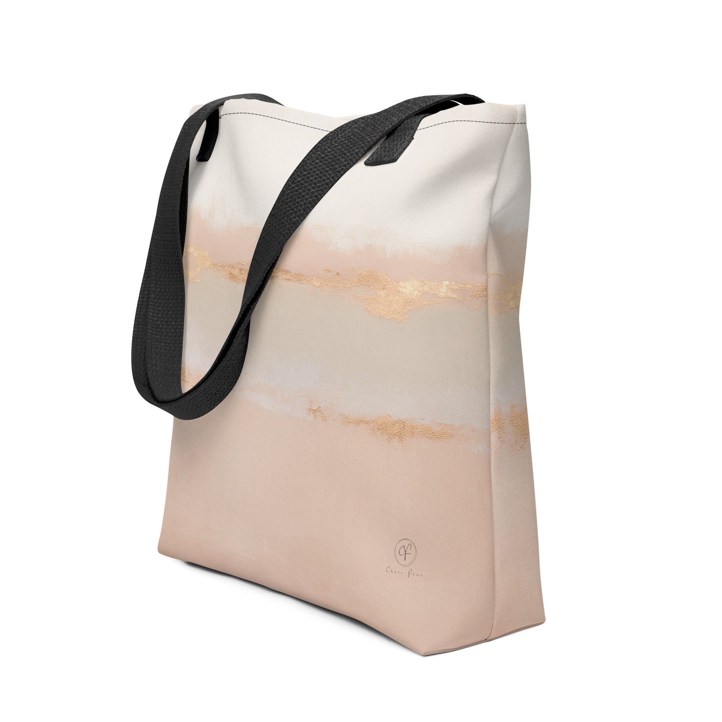 Beige and blush abstract tote bag with gold brushstroke accents and black handles on a white background.