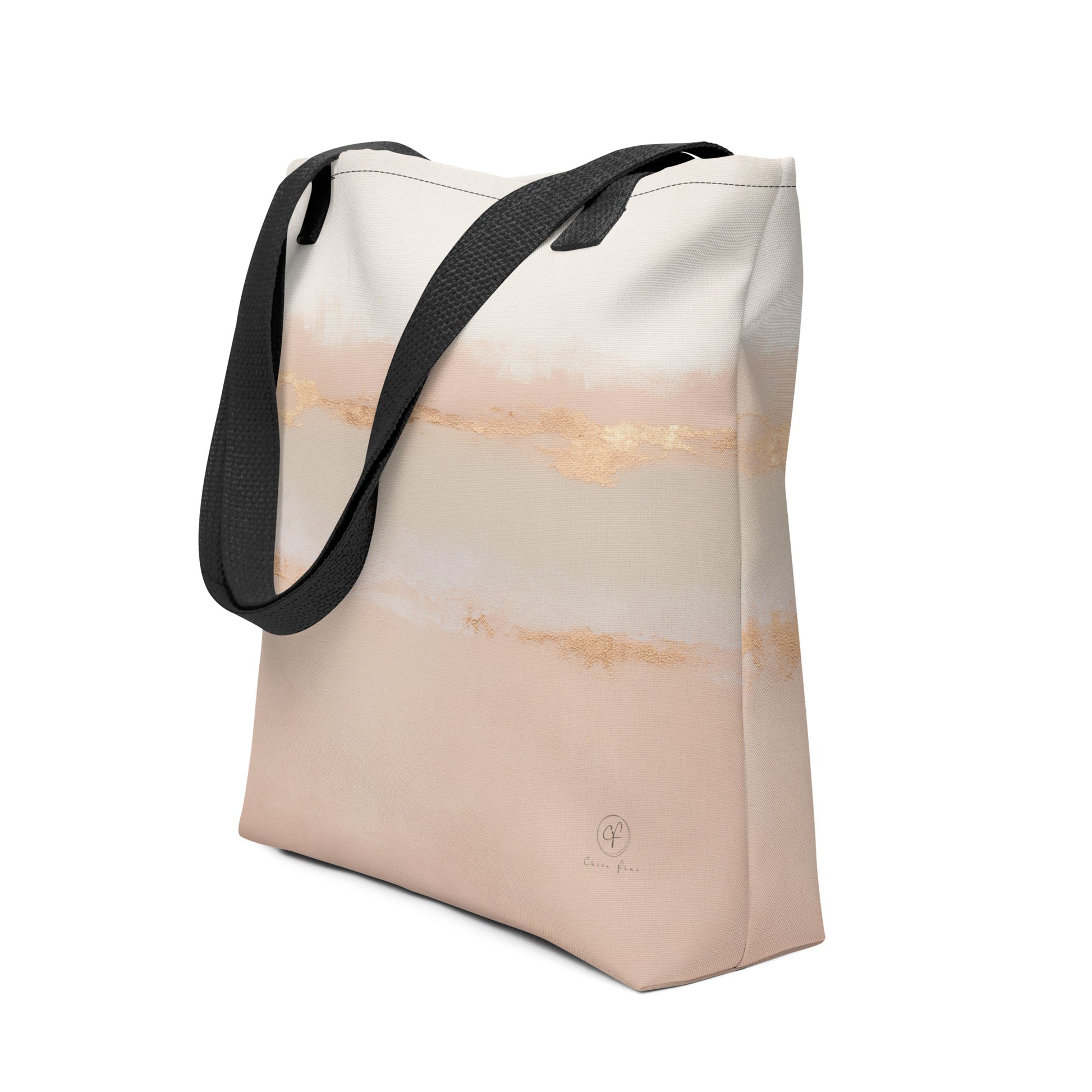 Beige and blush abstract tote bag with gold brushstroke accents and black handles on a white background.
