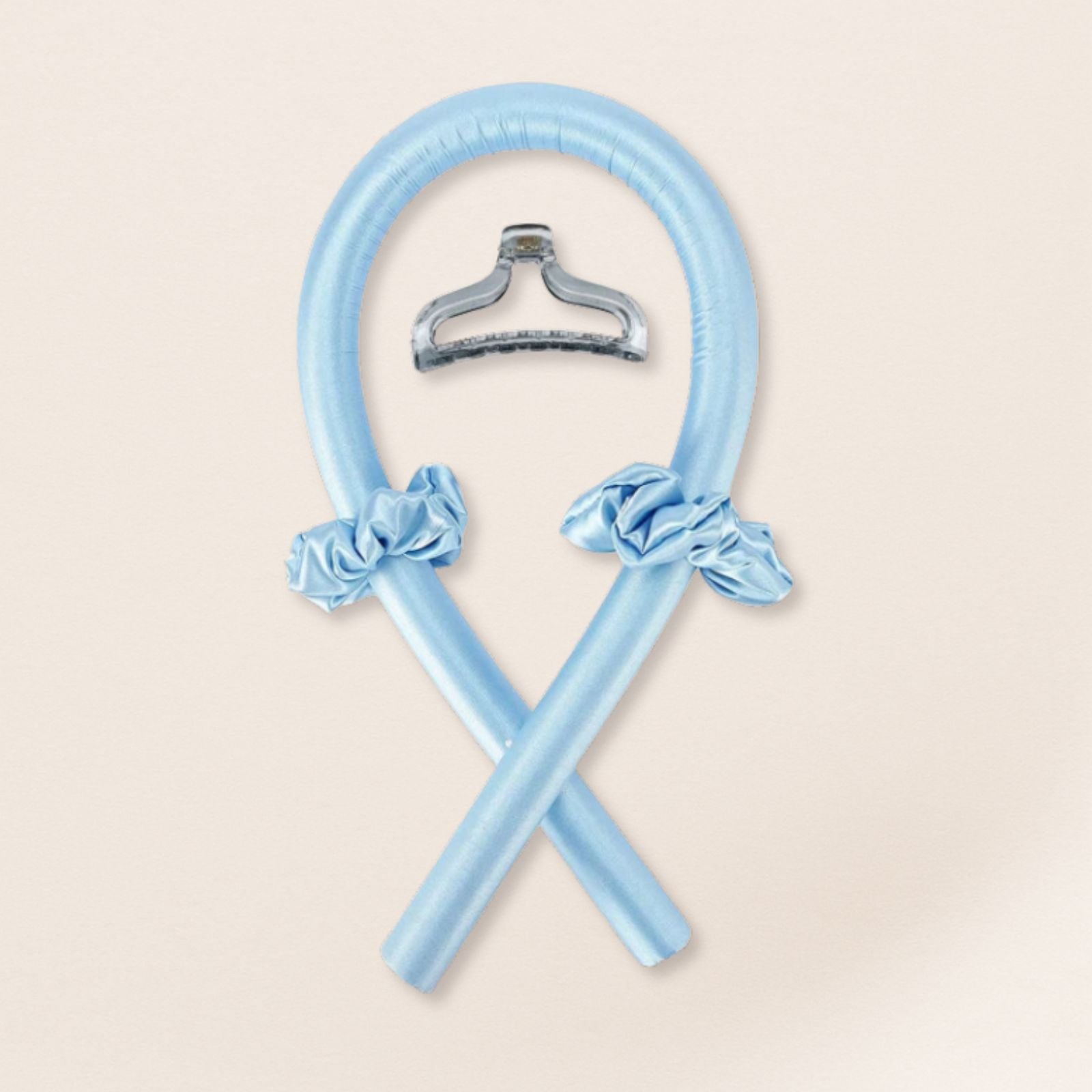 light blue heatless curling set with matching satin scrunchies and a translucent clip on a beige background