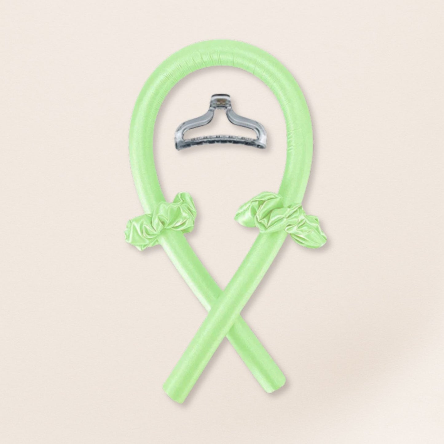 light green heatless curling set with matching satin scrunchies and a translucent clip on a beige background
