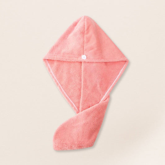 Pink microfiber towel for fine hair on a beige background