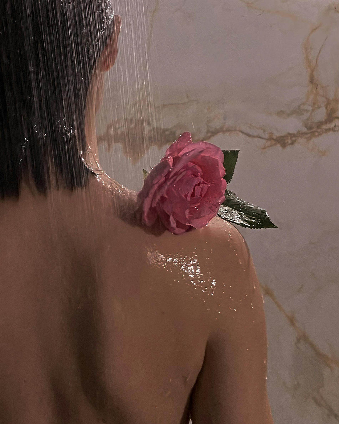 Woman with short Brown Hair, rose on shoulder 