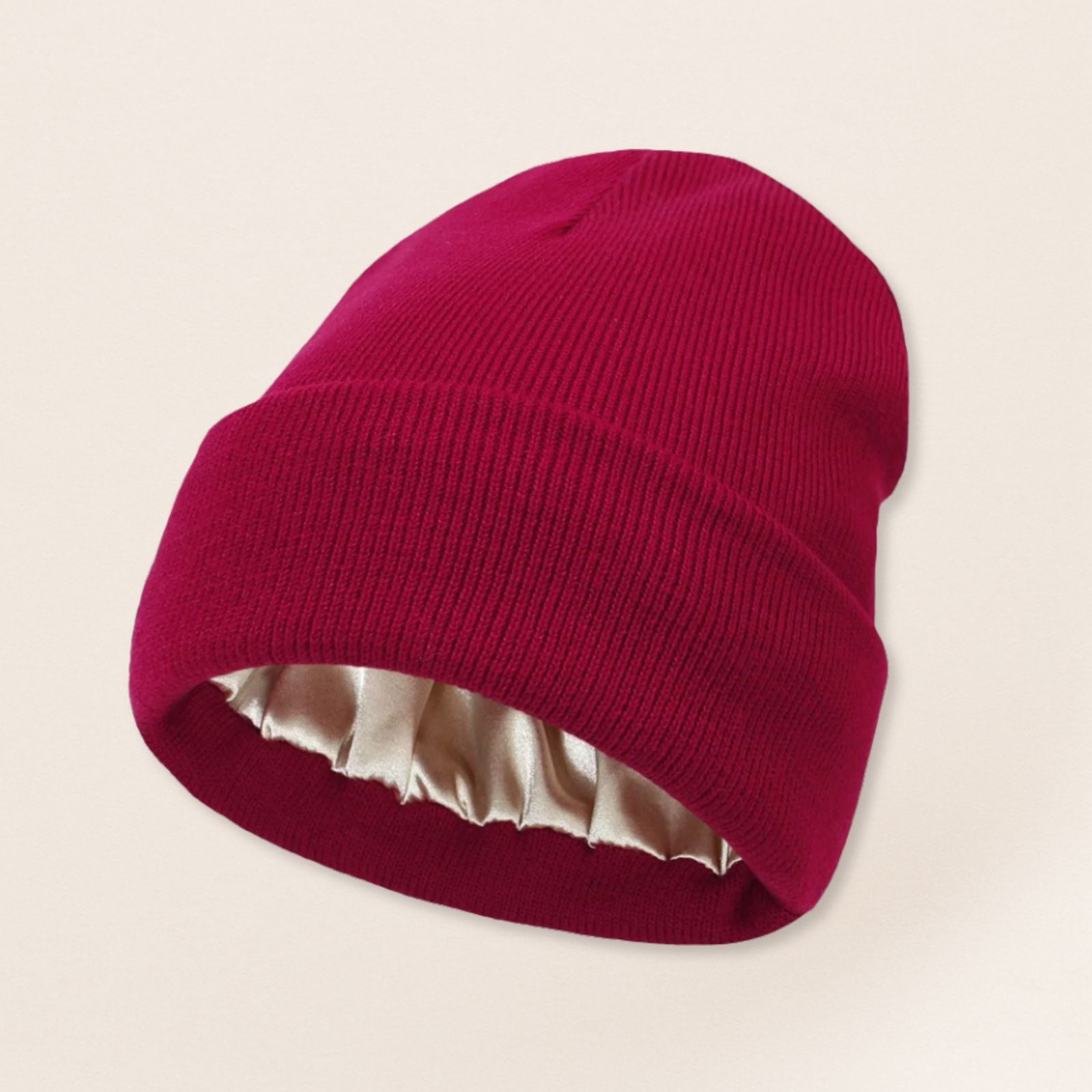 Red beanie with satin interior on a beige background