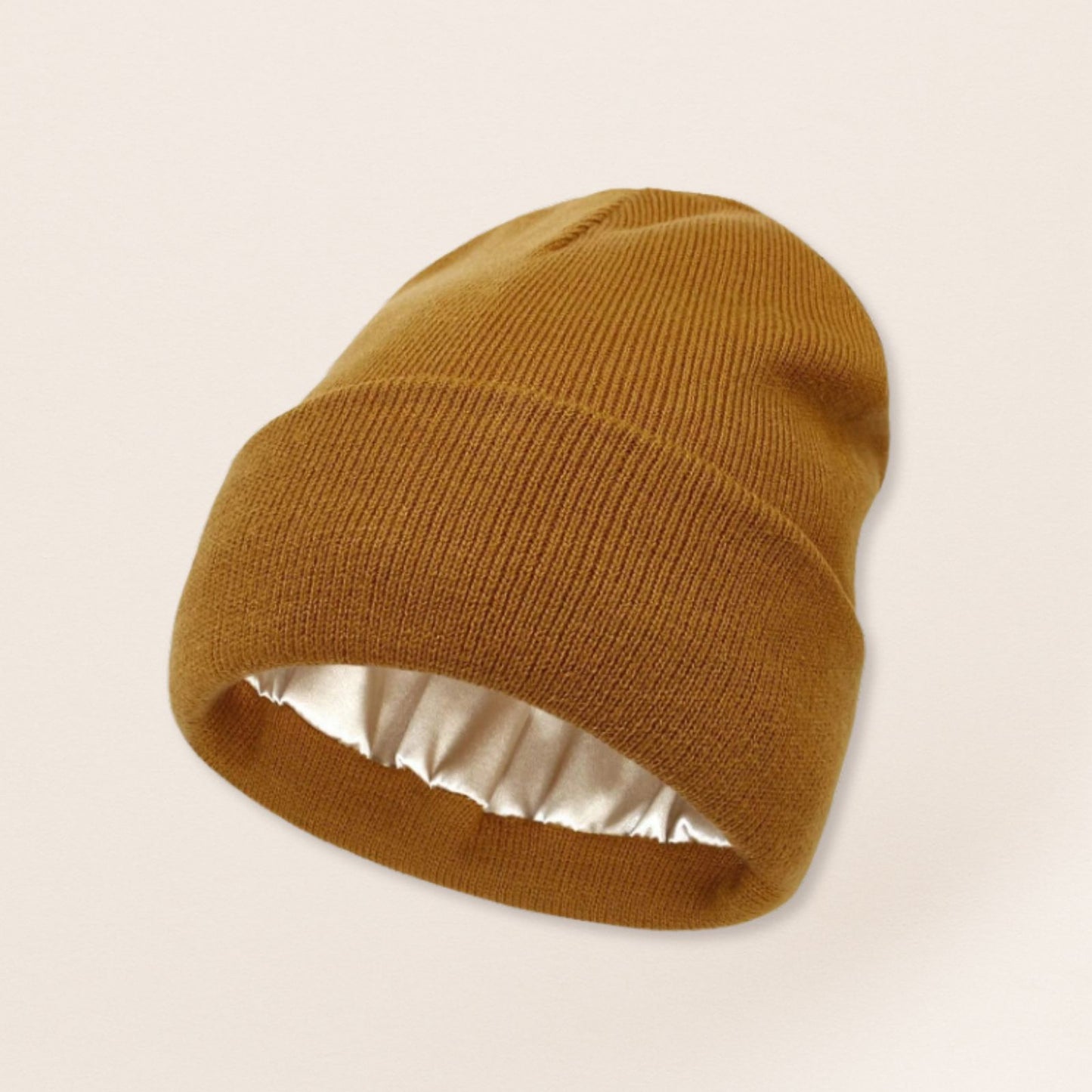 Brown beanie with satin interior on a beige background