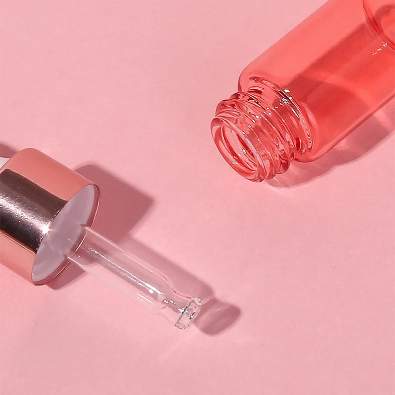 Pink dropper bottle on a pink background