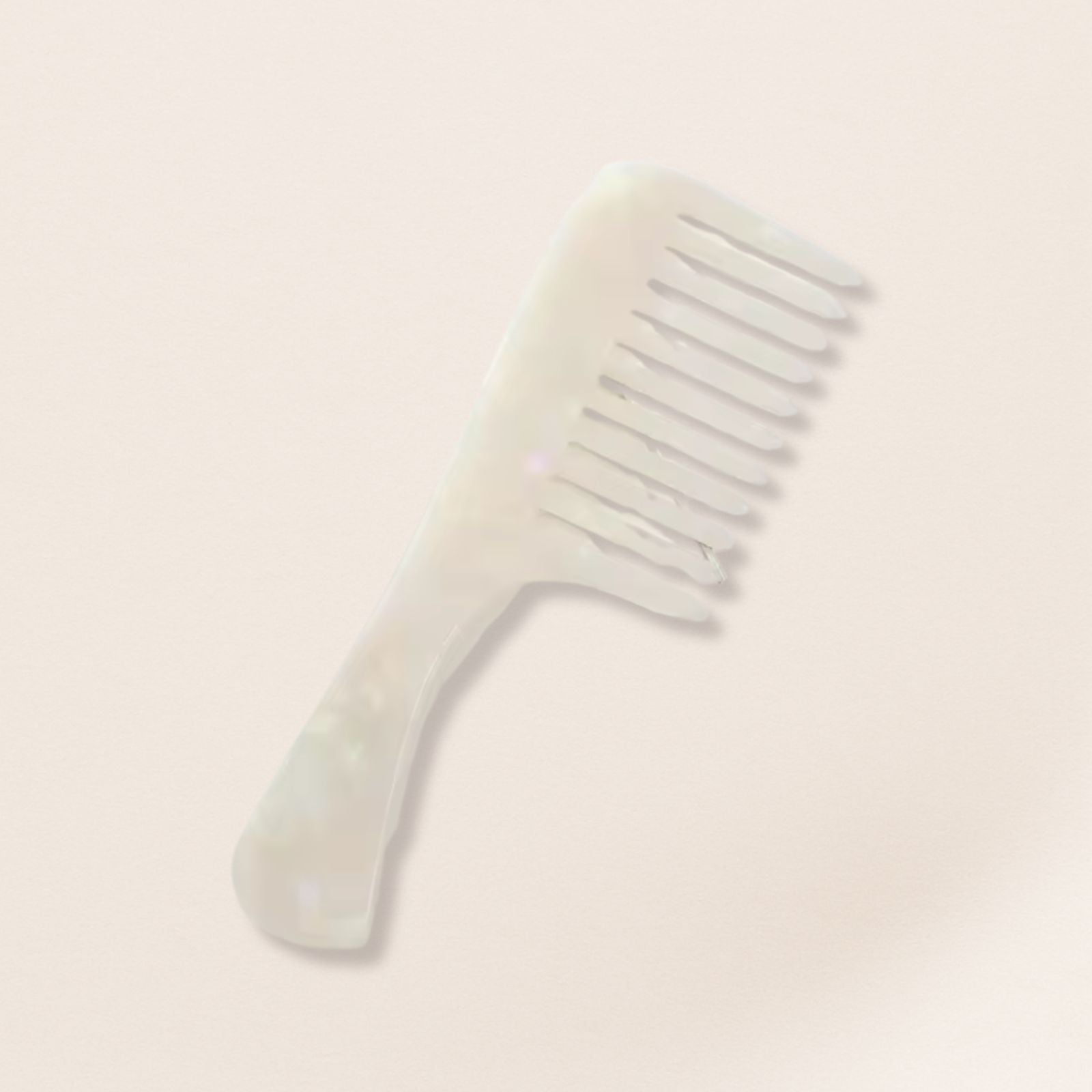 marbled wide-tooth combs for gentle detangling, displayed on a beige background.