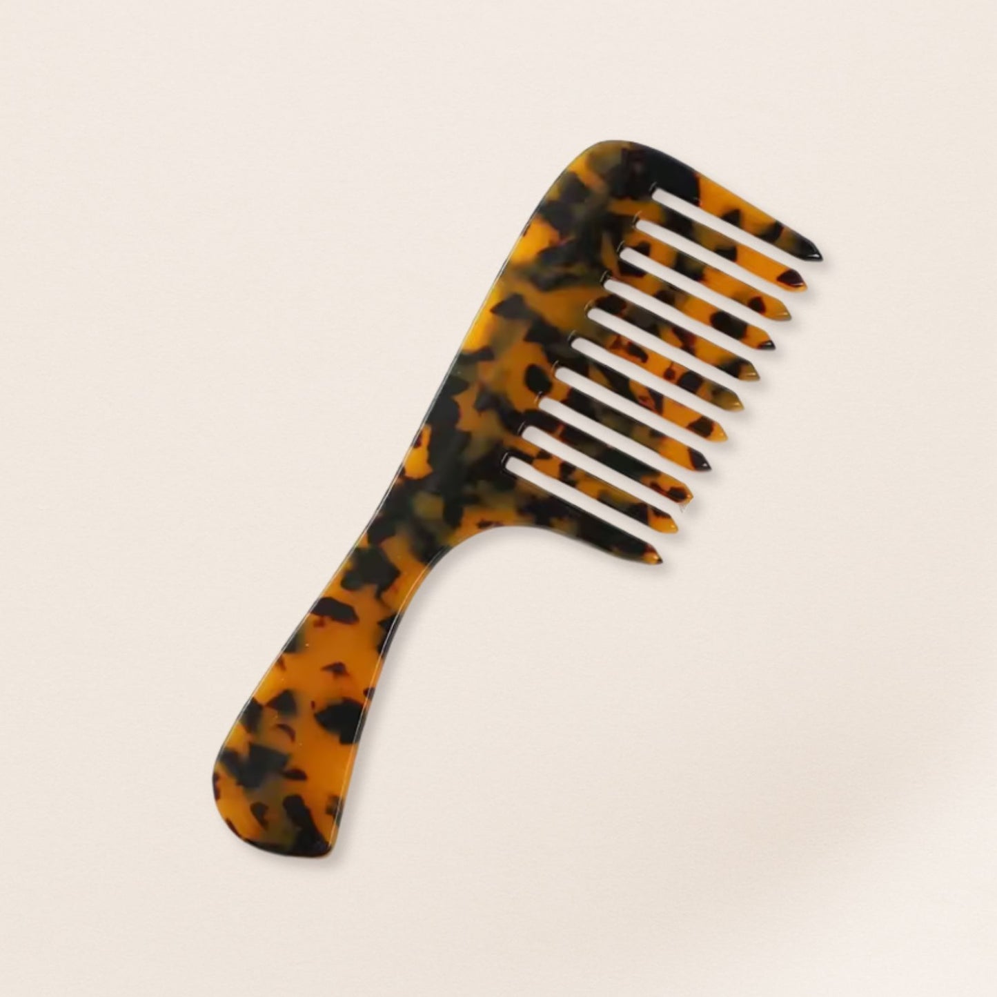 marbled wide-tooth combs for gentle detangling, displayed on a beige background.
