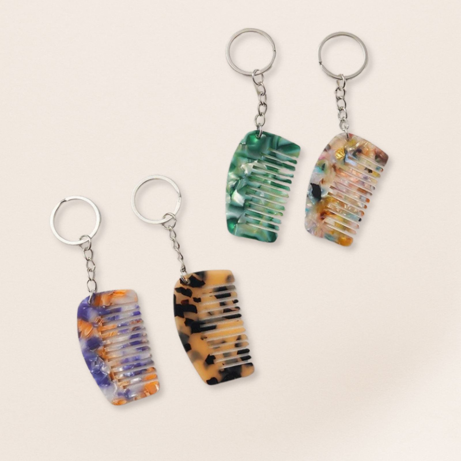 Four multicolored keychains shaped like flip-flops on a beige background