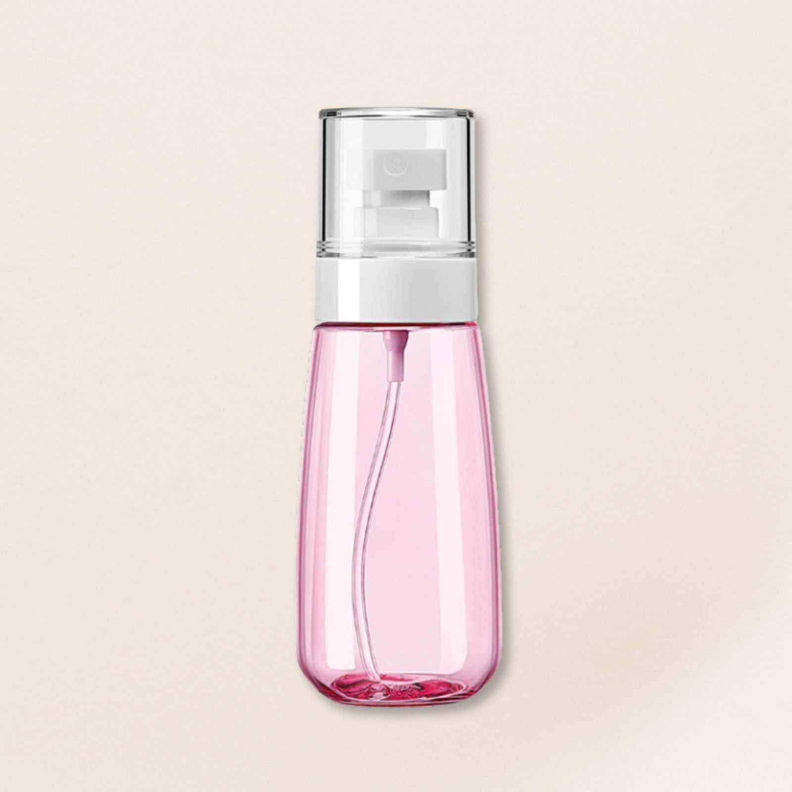 Pink spray bottle with a silver top on a beige background