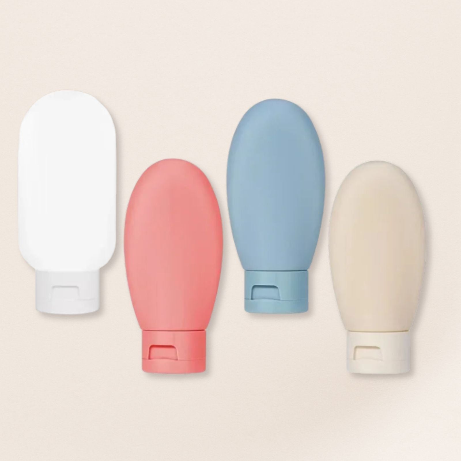 Four colourful bottles on a beige background