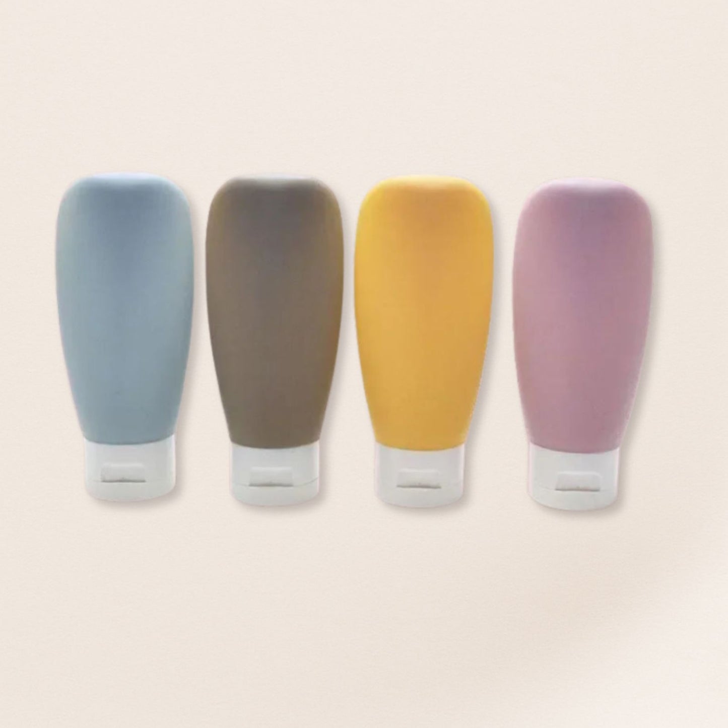 Four colorful silicone bottle covers on a beige background