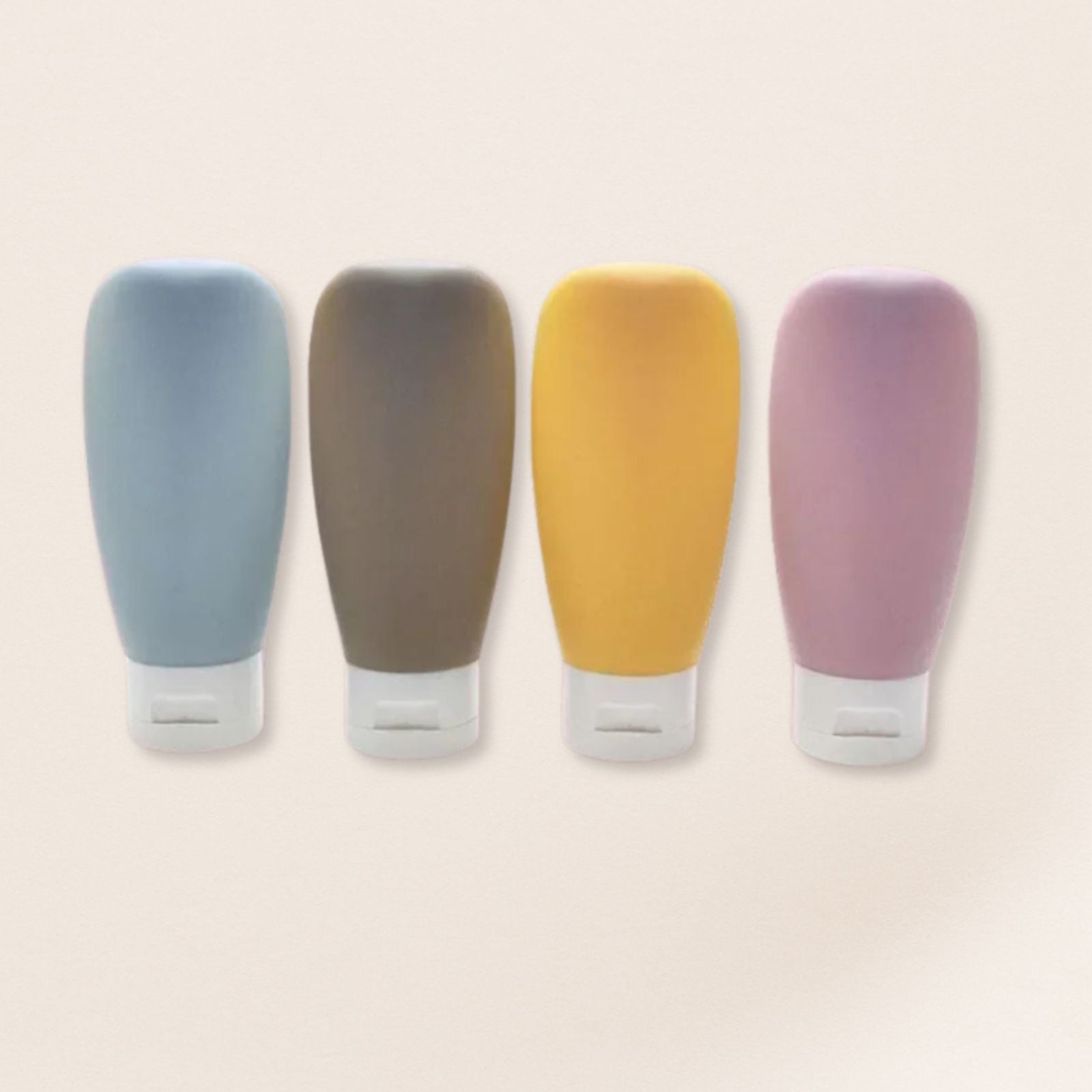 Four colorful silicone bottle covers on a beige background