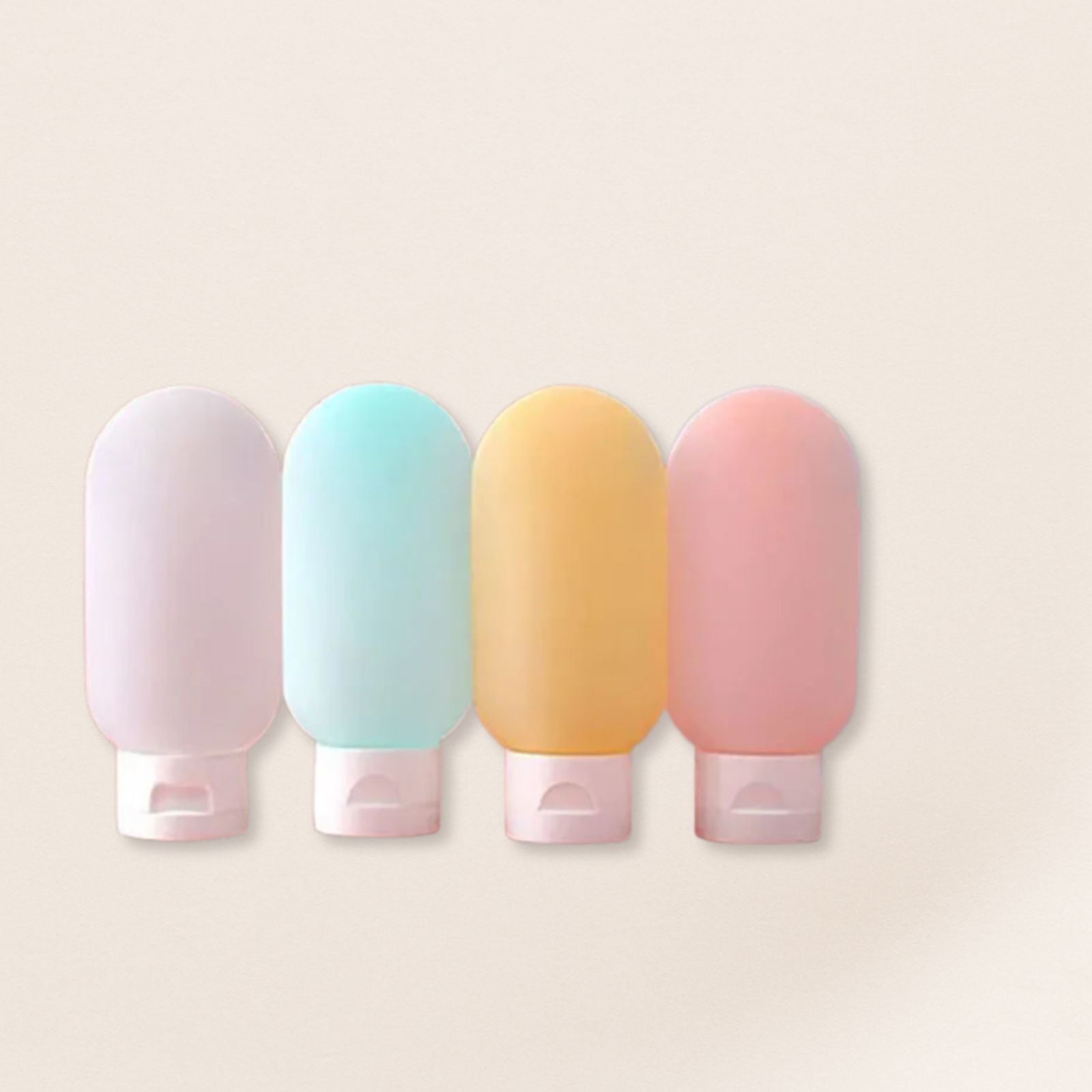 Four pastel-colored bottles with pink caps on a beige background